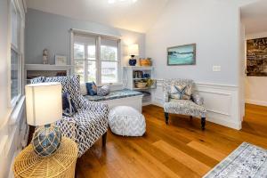 a living room with a couch and two chairs at Ferry Harbor Cottage in Falmouth