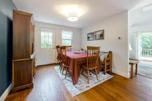 a dining room with a wooden table and chairs at Ferry Harbor Cottage in Falmouth +26 photos