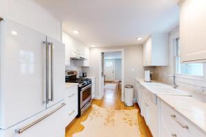 a white kitchen with white counters and white cabinets at Island Home in Vineyard Haven