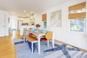 a dining room with a white table and chairs at Modern Beach & Town Getaway in Falmouth
