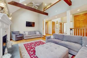 a large living room with a couch and a table at Sandbar Hideaway in Falmouth