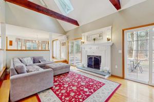 a living room with a couch and a fireplace at Sandbar Hideaway in Falmouth