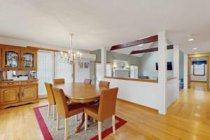 a dining room with a wooden table and chairs at Sandbar Hideaway in Falmouth