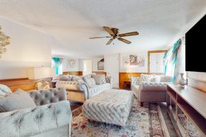a living room with couches and a ceiling fan at Coastal Charm on the Cape in Centerville