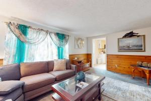 a living room with a couch and a table at Coastal Charm on the Cape in Centerville