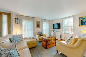 a living room with couches and chairs and a tv at Salty Ridge Station in Orleans