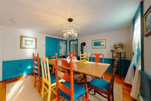 a dining room with a wooden table and chairs at Salty Ridge Station in Orleans