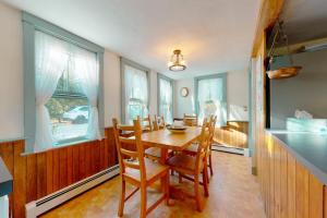 a dining room with a table and chairs and a bedroom at Salty Ridge Station in Orleans