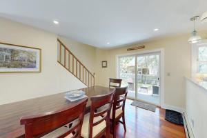 a kitchen and dining room with a table and chairs at Set Sail in Oak Bluffs