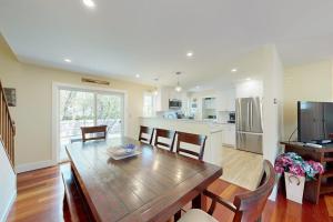 a kitchen and dining room with a wooden table and chairs at Set Sail in Oak Bluffs