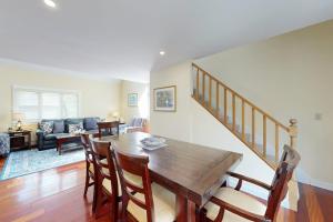 a living room with a wooden table and chairs at Set Sail in Oak Bluffs