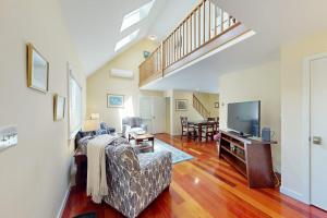 a living room with a couch and a tv at Set Sail in Oak Bluffs