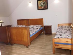 a small bedroom with two beds and a table at Agroturystyka pod Czarną Sosną in Biały Ług