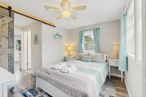a bedroom with a bed and a ceiling fan at Garage Suite in Oak Bluffs
