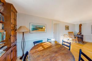 a dining room with a wooden table and chairs at Beachroad Hideout in Lobsterville +24 photos