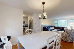 a kitchen and living room with a white table and chairs at Seabreeze in Dennis Port