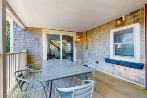 a wooden table and chairs on a patio at The Grey Lady in Provincetown