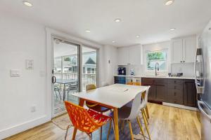 a kitchen with a table and chairs and a dining room at The Grey Lady in Provincetown
