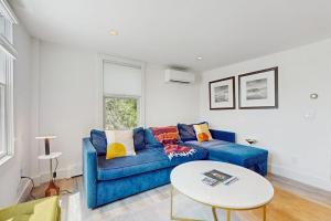 a living room with a blue couch and a table at The Grey Lady in Provincetown