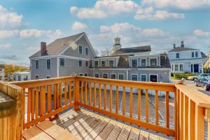 a large house with a wooden railing on a deck at Cape Point Escape in Provincetown