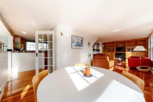 a living room with a white table and chairs at Cape Point Escape in Provincetown