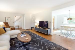 a living room with a couch and a tv at Wellfleet Harbor Hideaway in Wellfleet