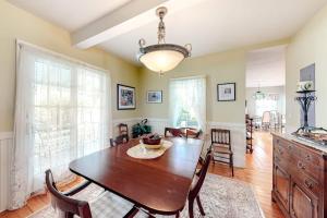 a kitchen and dining room with a table and chairs at Island Dream in Oak Bluffs
