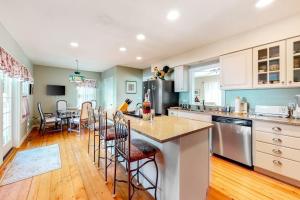 a kitchen with a island with chairs and a table at Island Dream in Oak Bluffs +22 photos