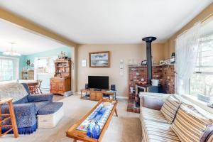 a living room with a couch and a tv at Summer Daze in Edgartown