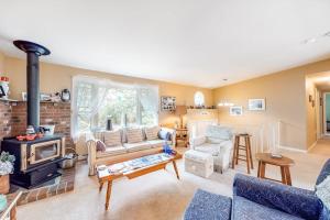 a living room with a couch and a fireplace at Summer Daze in Edgartown