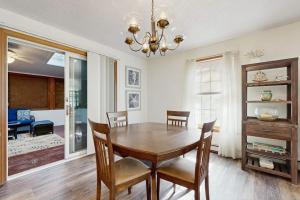 a dining room with a wooden table and chairs at Fallen Oak Retreat in Oak Bluffs