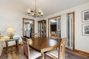 a dining room with a wooden table and chairs at Fallen Oak Retreat in Oak Bluffs