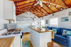 a caravan kitchen and living room with a blue couch at Beach Days in Dennis Port