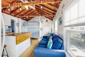 a living room with a blue couch in a rv at Beach Days in Dennis Port