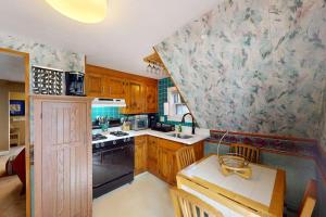a kitchen with wooden cabinets and a counter top at Provincetown Bliss in Provincetown