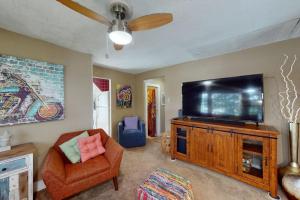 a living room with a flat screen tv and a couch at Provincetown Bliss in Provincetown