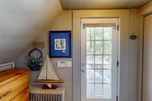 an attic room with a door and a staircase at Provincetown Bliss in Provincetown