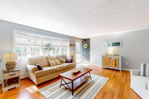 a living room with a couch and a table at Megansett Glen in North Falmouth