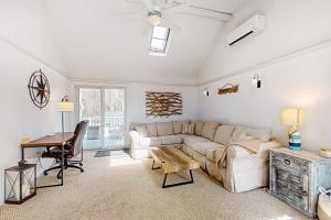a living room with a couch and a table at Megansett Glen in North Falmouth
