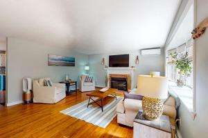 a living room with a couch and a fireplace at Megansett Glen in North Falmouth