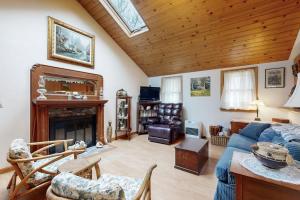 a living room with a blue couch and a fireplace at C-Haven in West Tisbury