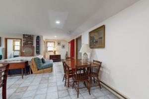 a living room with a bed and a table and chairs at C-Haven in West Tisbury