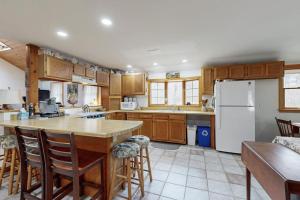 a kitchen with wooden cabinets and a white refrigerator at C-Haven in West Tisbury