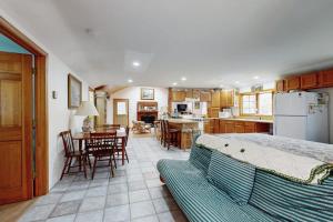 a bedroom with a bed and a kitchen with a table at C-Haven in West Tisbury