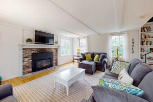 a living room with a couch and a fireplace at Saltwater Haven in Orleans