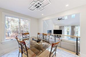 a dining room with a glass table and chairs at Tiffany's Treasure in Oak Bluffs +21 photos