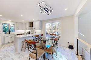 a kitchen with a glass table and chairs in it at Tiffany's Treasure in Oak Bluffs