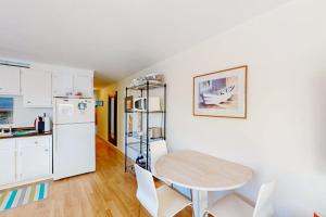 a kitchen with a table and chairs in a room at Beach Blessing in Provincetown