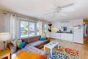 a living room with a couch and a kitchen at Beach Blessing in Provincetown