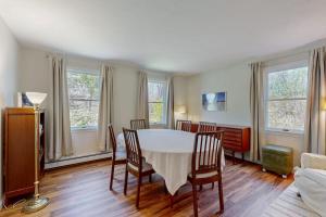 a dining room with a white table and chairs at Peace & Serenity in Falmouth